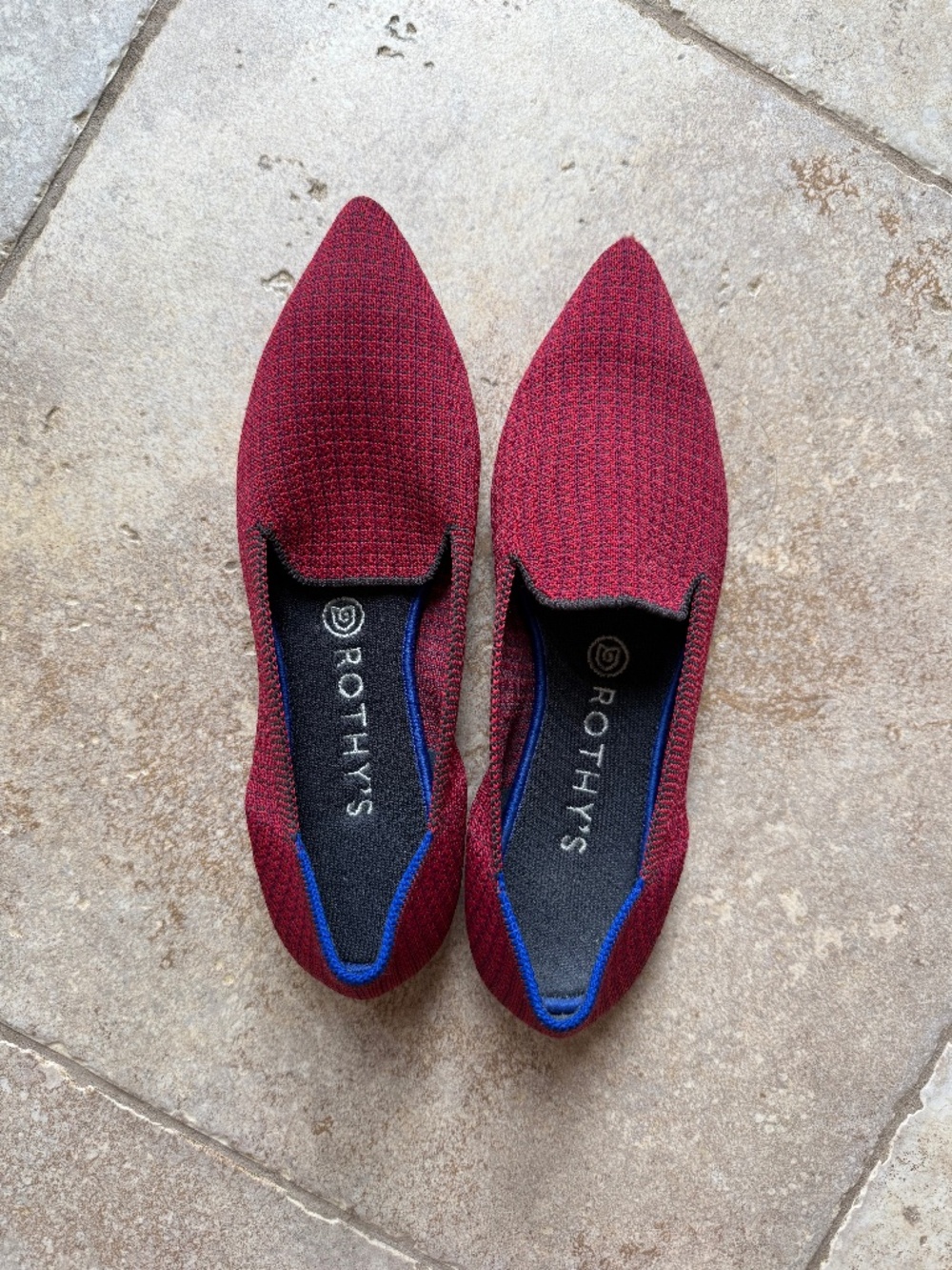 A pair of Rothy's The Point flats in a red/burgundy color
